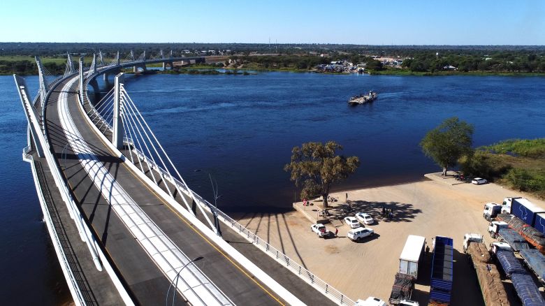An aerial view of the newly built Kazungula bridge over the Zambezi river in Kazungula, Botswana, on May 10, 2021. - A new road and rail bridge linking Botswana and Zambia was inaugurated on May 10, 2021, marking the completion of a multi-million-dollar project meant to ease congestion along border crossings in southern Africa.
The curved 923-metre-long Kazungula bridge built over the Zambezi River replaces a sluggish ferry crossing previously linking the two countries with a one-stop border post. (Photo by Monirul BHUIYAN / AFP) (Photo by MONIRUL BHUIYAN/AFP via Getty Images)