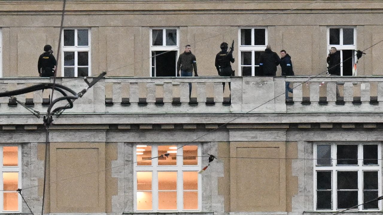 Armed police are seen on the balcony of the university in central Prague, on December 21, 2023. Czech police said Thursday a shooting in a university building in central Prague has left "dead and wounded people", without providing further details.