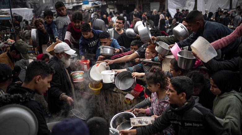 Palestinians converge for a free meal in Rafah, Gaza, on December 21, 2023.