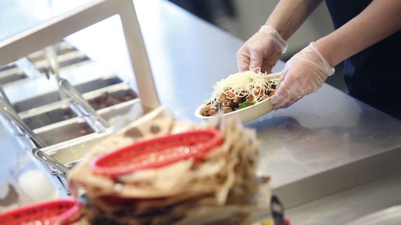 An employee prepares a burrito bowl at a Chipotle Mexican Grill Inc. restaurant in Louisville, Kentucky, U.S., on Saturday, Feb. 2, 2019.